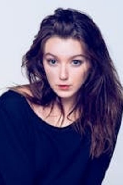 A woman with long hair and blue eyes.