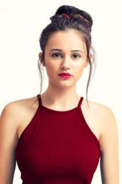 A woman in red shirt posing for the camera.